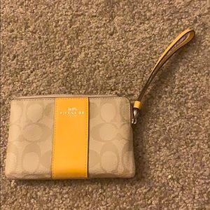 Coach wristlet - tan with cold stripe and strap